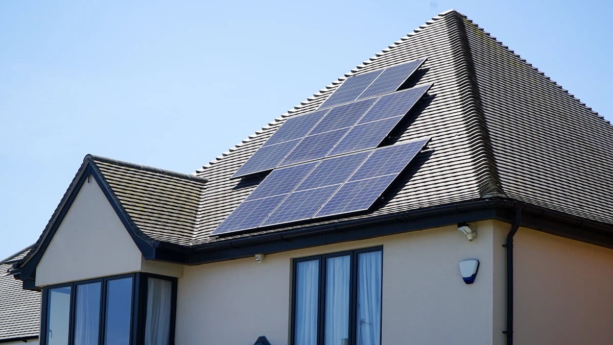 Rooftop solar panels on a house under a clear sky